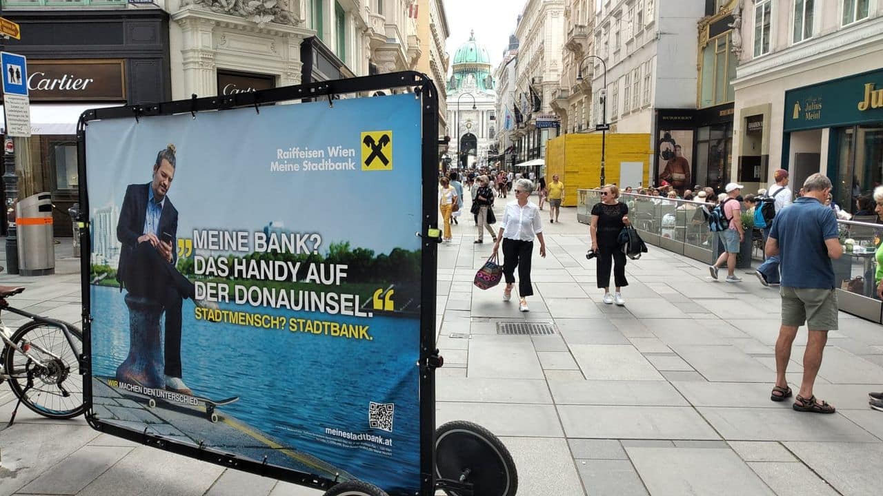 Adbike auf Einkaufsstraße in City mit Passanten